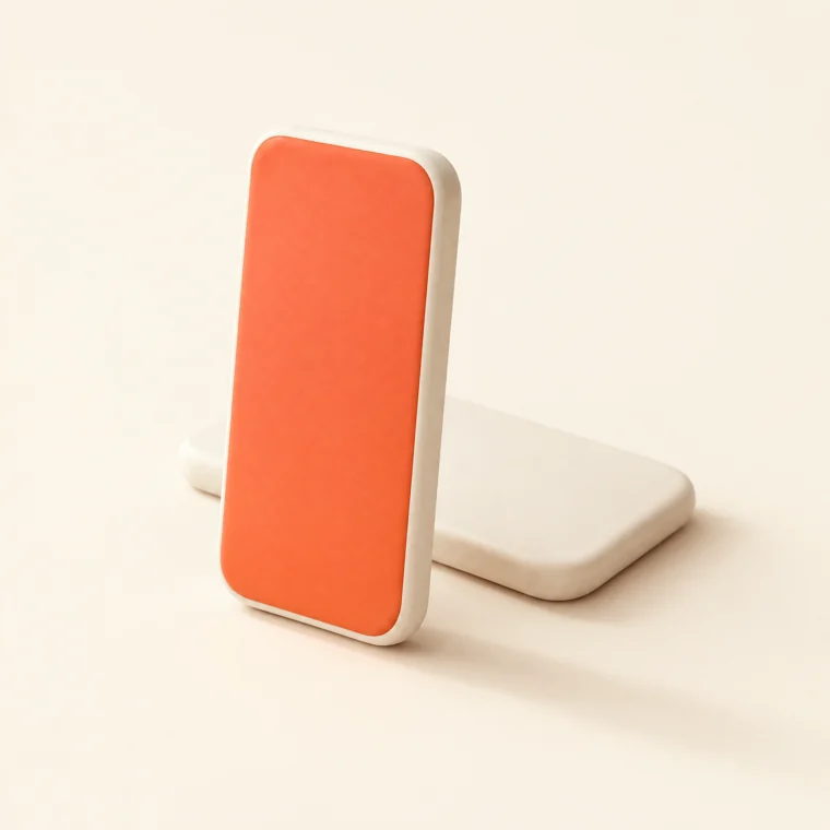 Two ceramic smartphones, the upright one with a coral face